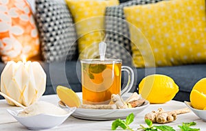 Hebal tea on table top with lemon, mint, ginger and other ingredients photo