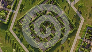 Hedge maze in city park. Labyrinth in the bushes. Beautiful summer in town, green trees. Apothecary garden in Gatovich.