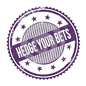 HEDGE YOUR BETS text written on purple indigo grungy round stamp