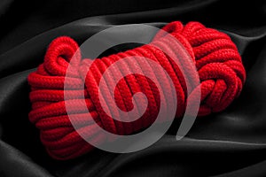 Hedonism, adult rope games and BDSM lifestyle concept with close up on a red soft ball of rope, used in the japanese erotic arts photo