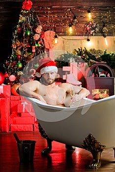 Hedonism concept. Stunning winter views enjoyed from bathtub. Apartment with bathtub. Man celebrate new year lying in photo