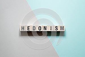 Hedonism word concept on cubes photo