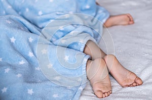 Heels and toes on bed. Heels and feets. Children`s feet. Barefeet on the bed. Kid`s feet in bed. Kids taking a rest