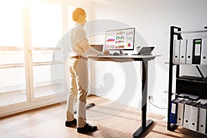 Height Adjusting Stand Desk In Office