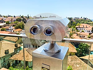 At the height of the houses of local residents with a tile roof. binoculars for tourists are installed on the roof. binoculars on