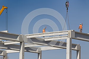 Height worker standing on truss on building skeleton