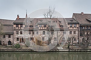 Heilig-Geist-Spital Hospice of the Holy Spirit in Old Town Nuremberg. View from the Museum Bridge on the on the River Pegnitz