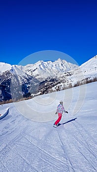 Heiligenblut - A snowboarder going down the slope photo
