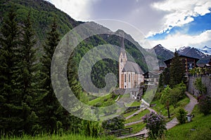 Heiligenblut with St Vincent Church in the background the beautiful Grossglockner. Beautiful sunny summer day in Austria.