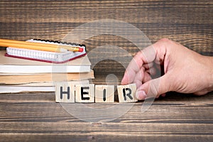 Heir concept. Wooden letters on the office desk photo