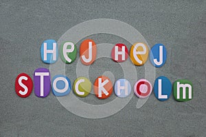 Hej Hej Stockholm, creative logo composed with multi colored stone letters over green sand photo