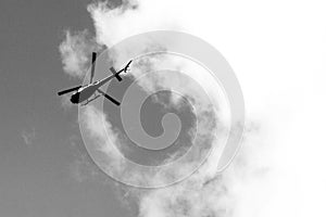 Helicopter against the sky in black and white