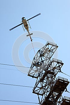 Helicopter Airlifting Workmen from Power Line