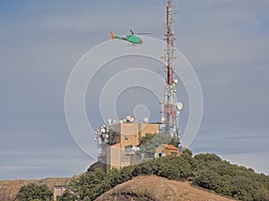 Helicopter approaching communications tower of Sant Jeroni