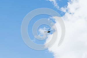 Helicopter on a background of blue sky with clouds