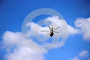 helicopter in the blue sky with heap clouds