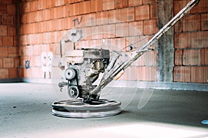 Helicopter concrete floor finishing. Construction worker finishing concrete screed with power trowel machine