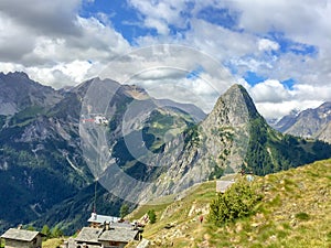 Helicopter conveying construction material in the Alps near Courmayeur Italy