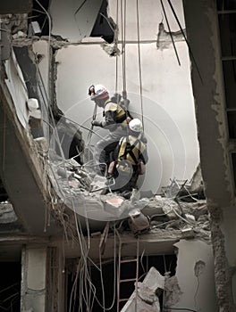 A helicopter crew lowering a specialized stretcher through a gaping hole in a badly damaged building.. AI generation