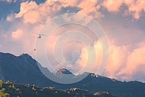 Helicopter extinguish a fire in mountains