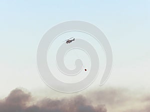 Helicopter extinguishes Forest fires, closeup. Provence, near Avignon, July 14, 2022