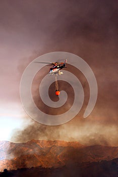 Helicopter with fire bucket, Spain.