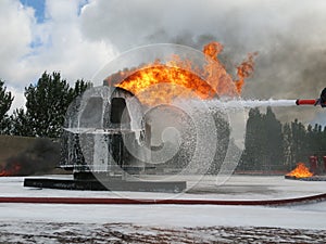 Helicopter fire fighting training. Non aspirated foam branch spraying heavy foam photo