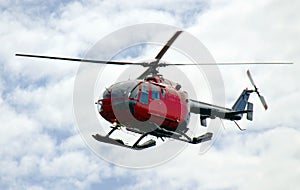 Helicopter in flight, cloudy sky