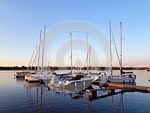 Helicopter fly while dusk over sailboat