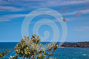 Helicopter flying above blue sea