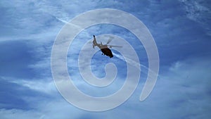 Helicopter flying against blue sky. Air transport aviation. Helicopter rescue.