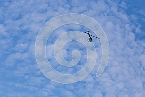 helicopter flying against blue sky