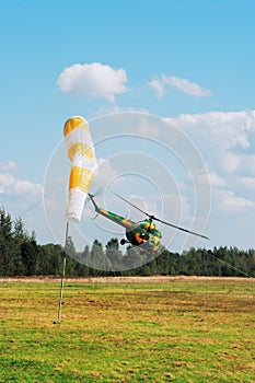 The helicopter is flying on airdrome photo