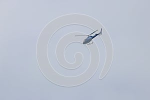 Helicopter flying in blue sky