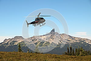 Helicopter flying close to the Black Tusk in Garibaldi Provincial Park, British Columbia