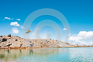 A helicopter flying over the beautiful Landscape view of Tongariro Crossing track. North Island, New Zealand