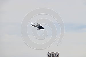 Helicopter flying over the city. Touring view