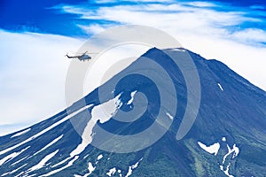 Helicopter flying over Ilyinsky Volcano and Kurile lake photo