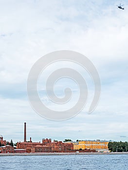 Helicopter flying over the Neva River in St. Petersburg, Russia and Kresty prison, vertical photo