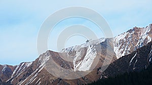 The helicopter is flying over the snowy mountains