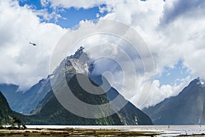 Helicopter flying past the giant Mitre Peak mountain of the Milf