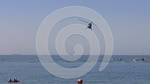 Helicopter flying sideways over water