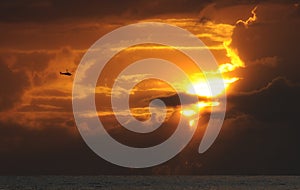 Helicopter flying at sunset