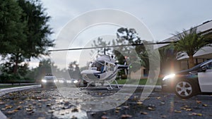 A helicopter with journalists or investigators flew in to investigate a recent crime. Scene with police vehicles parked