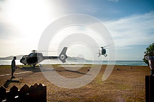 Helicopter landing on a helipad on a tropical island