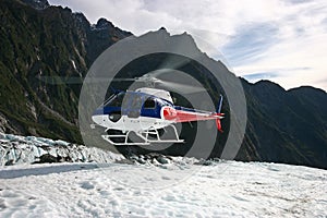 Helicopter landing on ice on mountain top