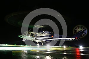 Helicopter landing in offshore oil and gas platform on deck or parking area. Helicopter night flight training of pilot