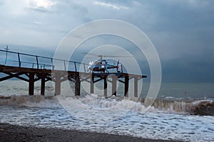 A helicopter lands people, during a gale. Marine gale