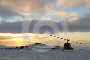 Helicopter at Mount Erebus in Antarctica photo