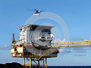 The Helicopter from onshore landing on offshore buildings for passenger transfer to work at offshore oil and gas platforms